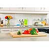 Modern kitchen interior with fresh vegetables on natural stone countertop