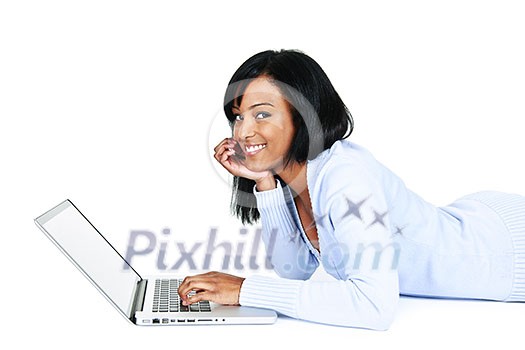 Smiling black woman using computer laying on floor looking at camera Smiling black woman using computer laying on floor looking at camera