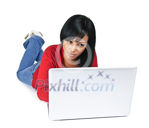 Black young woman typing on computer laying on floor Black young woman typing on computer laying on floor