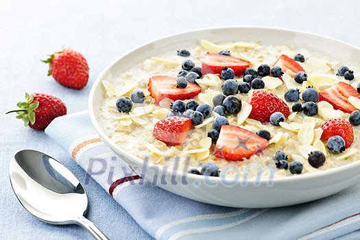 Bowl of hot oatmeal breakfast cereal with fresh berries Bowl of hot oatmeal breakfast cereal with fresh berries