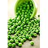 Closeup on spilling bowl of fresh green green peas