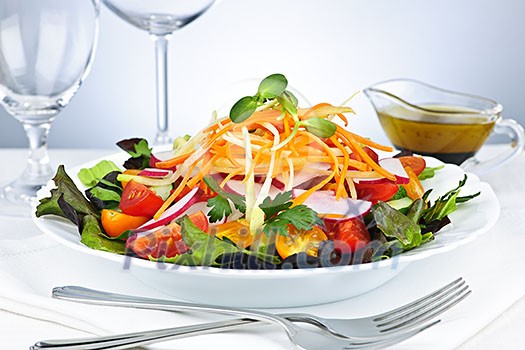 Plate of healthy green garden salad with fresh vegetables served with balsamic dressing Plate of healthy green garden salad with fresh vegetables served with balsamic dressing