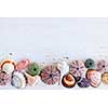 Border of Mediterranean seashells, urchins and rocks on painted wood background