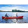 Family canoeing on sunny Lake of Two Rivers, Ontario, Canada