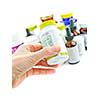 Hand holding medicine bottle to read label