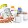 Hand holding medicine bottle to read label