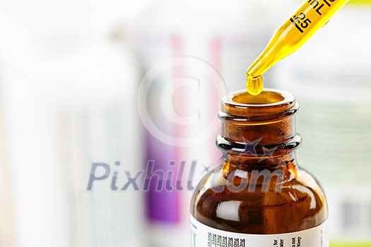 Closeup of liquid medicine in glass dropper and bottle Closeup of liquid medicine in glass dropper and bottle