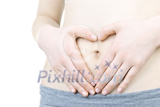 Woman showing heart shape with her hands on stomach Woman showing heart shape with her hands on stomach