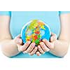 Globe of the planet Earth held in young female hands