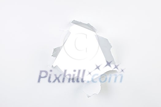 Paper with ripped hole and torn edges over white Paper with ripped hole and torn edges over white