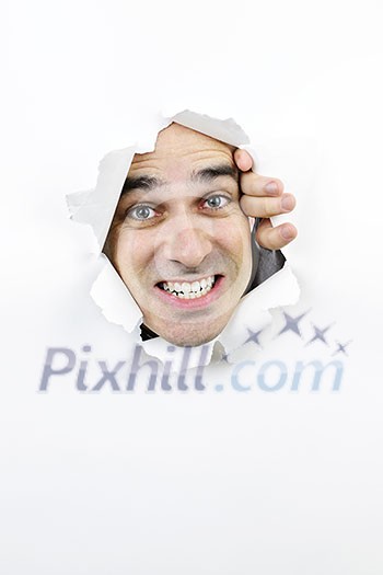 Hole in paper with angry man looking through Hole in paper with angry man looking through