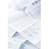 Paper cash register receipts in a lose pile close up