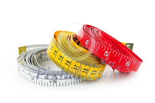 Three colorful measuring tapes coiled on white background Three colorful measuring tapes coiled on white background