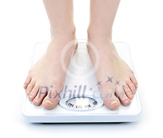 Bare female feet standing on bathroom scale Bare female feet standing on bathroom scale