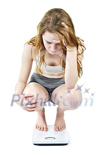 Young woman on bathroom scale worrying about her weight Young woman on bathroom scale worrying about her weight