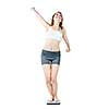 Happy joyful young woman standing on bathroom scale isolated on white
