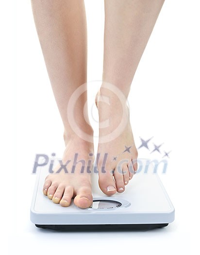 Bare female feet standing on bathroom scale Bare female feet standing on bathroom scale