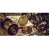 Old vintage retro compass and spyglass on ancient world map. Vintage still life. Travel geography navigation concept background.