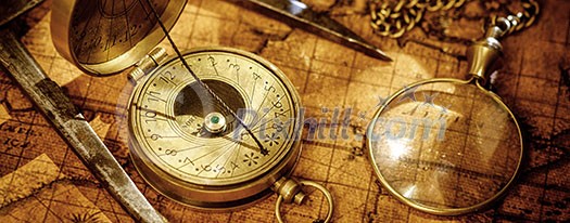 Old vintage retro compass, measuring devices and magnifying glass on ancient world map. Vintage still life. Travel geography navigation concept background. Old vintage retro compass, measuring devices and magnifying glass on ancient world map. Vintage still life. Travel geography navigation concept background.