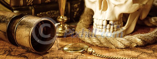 Old vintage candlestick, skull and spyglass on ancient world map. Vintage still life. Travel geography navigation concept background. Old vintage candlestick, skull and spyglass on ancient world map. Vintage still life. Travel geography navigation concept background.