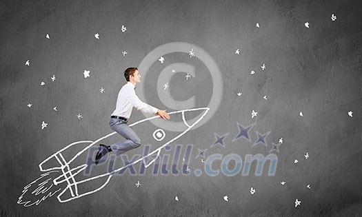 Young businessman flying in sky on drawn rocket Young businessman flying in sky on drawn rocket
