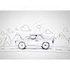 Young man driving car made of sheet of paper