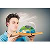 Young man in casual holding opened book with city model. Elements of this image are furnished by NASA