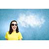 Young girl teenager in sunglasses and yellow shirt