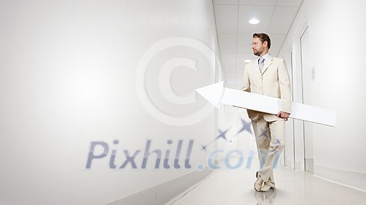 Businessman in suit with white blank arrow in hands Businessman in suit with white blank arrow in hands