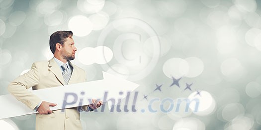 Businessman in suit with white blank arrow in hands Businessman in suit with white blank arrow in hands