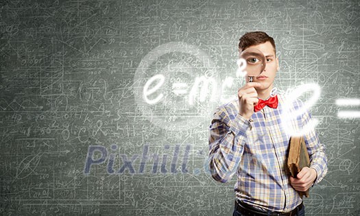 Young funny science man looking in magnifier Young funny science man looking in magnifier