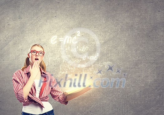 Young funny girl with opened book in hands Young funny girl with opened book in hands