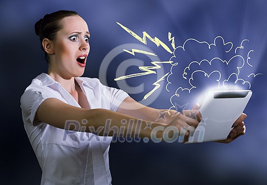 Young pretty surprised woman using tablet pc Young pretty surprised woman using tablet pc