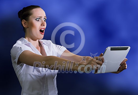 Young pretty surprised woman using tablet pc Young pretty surprised woman using tablet pc