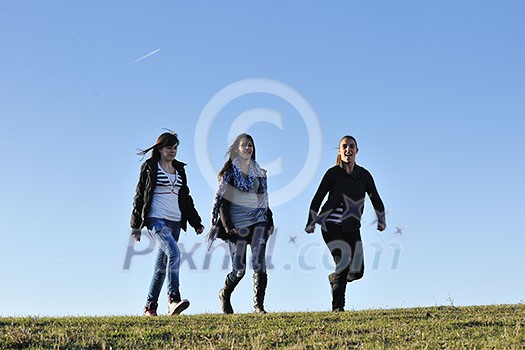 group of teen people woman have fun outdoor with blue sky in background group of teen people woman have fun outdoor with blue sky in background