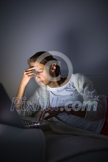Very tired young woman, burning the midnigh oil - working late at night on her laptop computer, at home, sitting on sofa, rubbing her tired eyes, trying to stay focused Very tired young woman, burning the midnigh oil - working late at night on her laptop computer, at home, sitting on sofa, rubbing her tired eyes, trying to stay focused