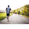 Male athlete/runner running on road - jog workout well-being concept