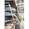 Man choosing and buying construction wood in a DIY store for his DIY home re-modeling project