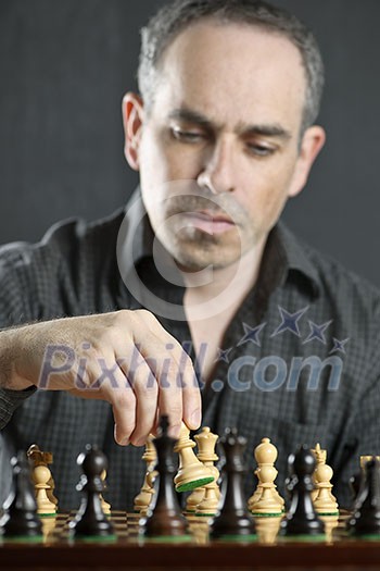 Man moving a chess pawn on wooden chessboard as first move Man moving a chess pawn on wooden chessboard as first move