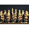 Close up of chess pieces on wooden chessboard