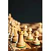 Close up of white chess pieces on wooden chessboard