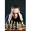 Chessboard with man thinking about chess strategy