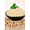 Bowl of fresh hummus with raw organic chickpeas