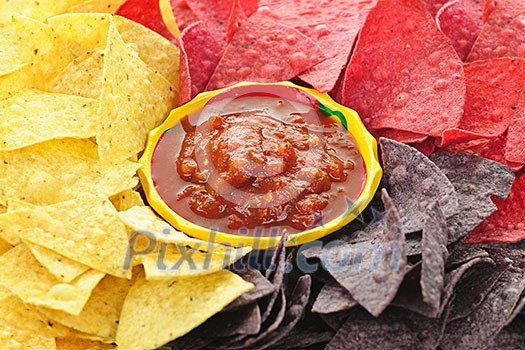 Bowl of salsa with colorful tortilla chips Bowl of salsa with colorful tortilla chips