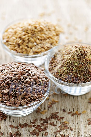 Bowls of whole and ground flax seed or linseed Bowls of whole and ground flax seed or linseed