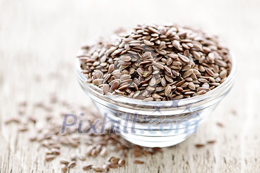 Bowl full of brown flax seed or linseed Bowl full of brown flax seed or linseed