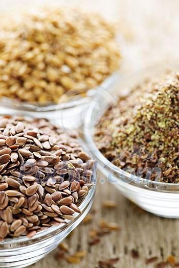 Bowls of whole and ground flax seed or linseed Bowls of whole and ground flax seed or linseed