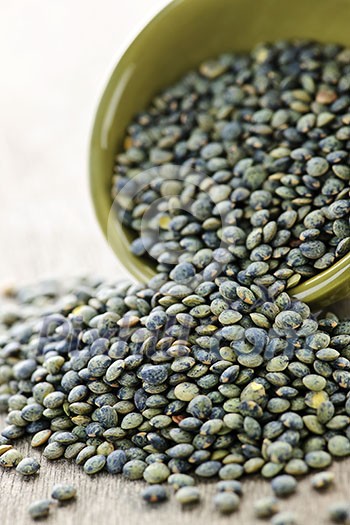 Bowl full of raw french green lentils Bowl full of raw french green lentils