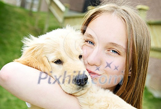 Portrait of smiling teenage girl holding golden retriever puppy Portrait of smiling teenage girl holding golden retriever puppy