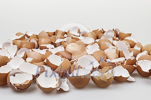 Pile of many broken brown empty eggshells Pile of many broken brown empty eggshells